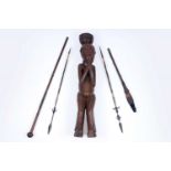 An African carved hardwood figure; and four spears