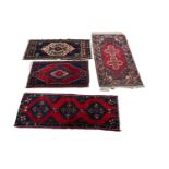 A collection of hand-woven Turkish woollen prayer mats and a runner