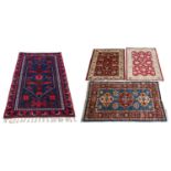 A collection of four rugs