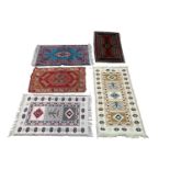 A collection of five rugs