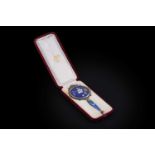 A late 19th Century French silvergilt mounted enamel hand mirror