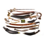 A selection of reproduction swords and other edged weapons