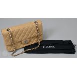 Chanel - A classic tan quilted leather hand bag, with tan leather interior, white metal hardwear,