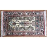 An Indian Kashmir silk floral prayer rug, ivory field with a mehrab-arch framing the stylised tree