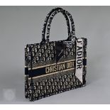 Christian Dior - A book tote bag, with two loop handles, woven Dior logo and Christian Dior Paris to