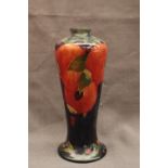 'POMEGRANATE' A MOORCROFT POTTERY VASE A tall baluster-form vase on a spreading circular foot with