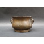 A Chinese bronze censer of gui form with everted rim and twin lion mask handles,