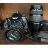 A Canon EOS 70D digital SLR camera with Canon EF-S 18-55mm IS zoom lens, lens hood,