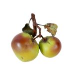 A contemporary porcelain trompe l'oeil ornament, naturalistically modelled as two apples on a
