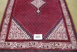 A North West Persian Arak rug, central motif cream on red ground. 150cm x 100cm approx. Condition