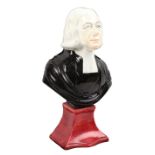 An early 19th Century Staffordshire portrait bust of the Methodist preacher John Wesley, raised on a