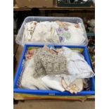 Two boxes of laced and embroidered table cloths and soft goods