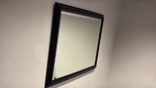Rectangular black-framed wall mirror