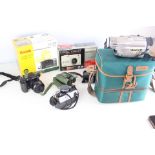 An Assortment of Vintage Digital Cameras, a Digital Camcorder, and Photographic Accessories