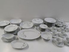 A Limoges part dinner/tea service decorated with dandelions on white background with silver rim