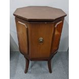 A reproduction mahogany octagonal cabinet having a single door and on sabre legs, 70cm h x 45.5cm