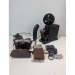 A mixed lot to include a vintage tinplate hand crank projector, a vintage Voigtlander Vito II 65mm