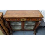 An early 19th century mahogany chiffonier having brass inlaid, two drawers above cupboards, scroll