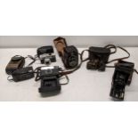 Vintage film cameras and a binocular to include a Zeiss Ikon Ikoflex twin lens reflex, black body,