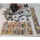 A mixed group of collectables to include a collection of postcards, mixed brass items, a table