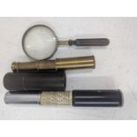 An Otis King pocket calculator along with a cased pocket telescope and a magnifying glass