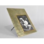 A Vintage Brass Photo Frame with Textured Crocodile Patterned Finish Containing Black and White