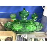 AN ART DECO GREEN GLASS DRESSING TABLE SET, INCLUDING, TRAY, CANDLESTICKS, BOWL AND LIDDED JARS,