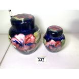 TWO MOORCROFT LIDDED GINGER JARS, GRADUATED IN SIZE, HEIGHT OF LARGEST, 15CM