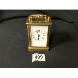 A BRASS CARRIAGE CLOCK WITH WHITE ENAMEL DIAL, HEIGHT 11CM, HANDLE DETACHED