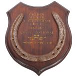 HORSE RACING INTEREST - a Vintage iron horseshoe mounted on wooden shield inscribed "Golden