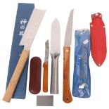 A Japanese Nisaku Hori Hori steel garden knife and sheath, Japanese folding garden saw, a hand