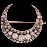 A fine Antique Victorian gold and silver diamond crescent moon brooch, circa 1880, the crescent