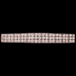 An Art Deco platinum diamond panel brooch, circa 1920, elongated tonneau form, each panel set with 6