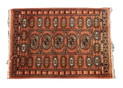 PAKISTAN BOKHARA SMALL RUG, pale wine red with single row of five guls, star patterned border, 2'