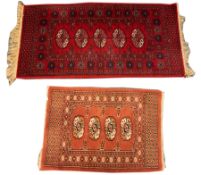 PAKISTAN BOKHARA WINE RED RUG with a single row of five black and white stencilled guls, star