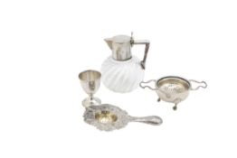 A German silver jug, two tea strainers, and an egg cup