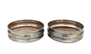 A pair of silver wine coasters