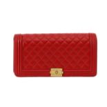 A Chanel 'Boy' red lambskin flap clutch bag