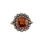 A hessonite garnet and diamond cluster ring