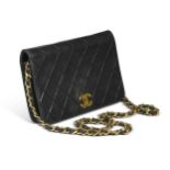 A Chanel diamond quilted wallet on a chain,