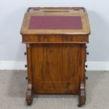 A Victorian rosewood Davenport Desk, with red leather writing surface revealing a fitted interior,