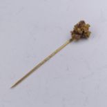 An unworked gold Nugget, mounted onto a gold stick pin, nugget approx. 18.8mm long, 15mm wide at