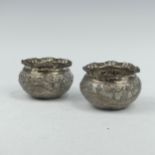 A pair of Eastern white metal Rice Bowls, with continuous scene decoration of a riverscape and