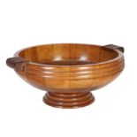 An Art Deco treen fruitwood fruit bowl, with twin handles On a turned base