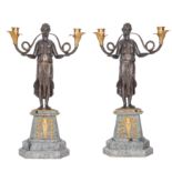 A pair of Empire style patinated and gilt bronze figural two light candelabra mid 20th century