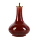 A Chinese copper-red-glazed vase, Qing dynasty, 18th century 清十八世紀 紅釉長頸瓶
