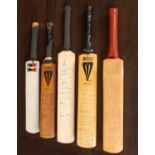 A collection of signed miniature commemorative cricket bats