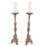 A pair of brass altar-style candlesticks