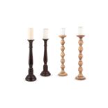 A pair of turned beechwood candlesticks