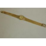 A 9ct gold Tissot lady's cocktail watch with gold strap, 26.8g